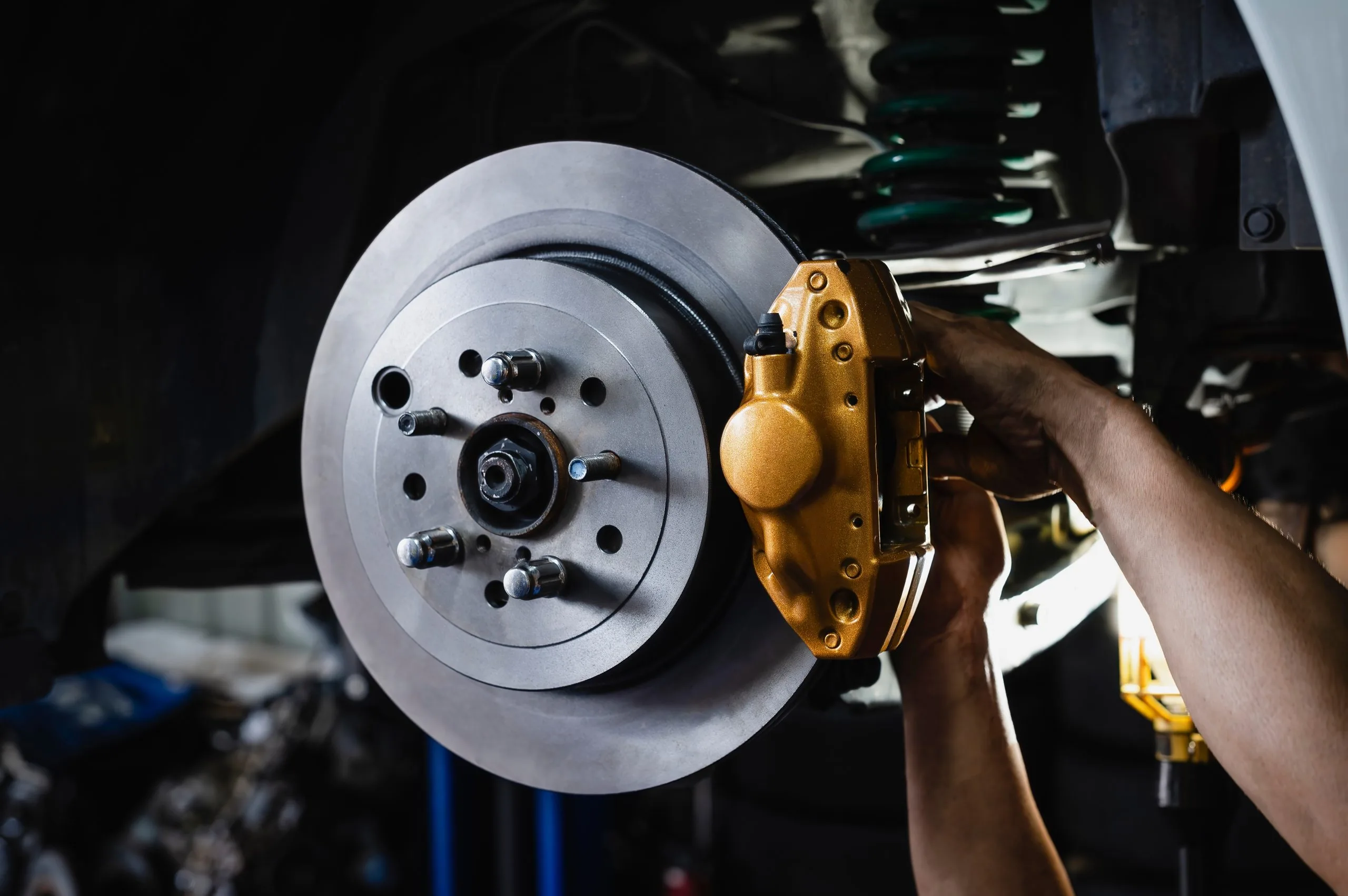 Auto,Mechanic,Installing,Two,Piston,Brake,Calipers,And,Disc,Brake